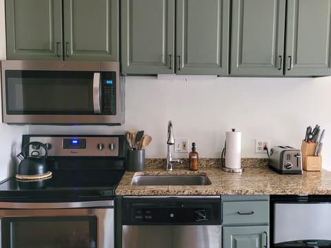 Fully equipped kitchen w/ a mini-fridge that has a separate freezer and fridge.