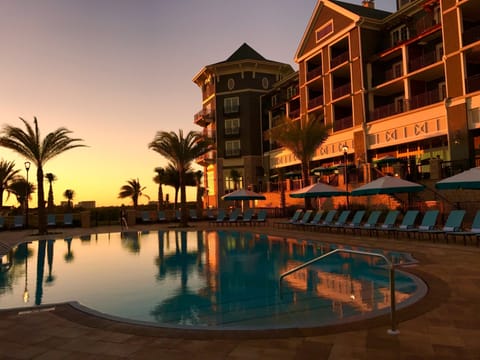  Resort pool captured at dusk, reflecting the warm glow of the setting sun.