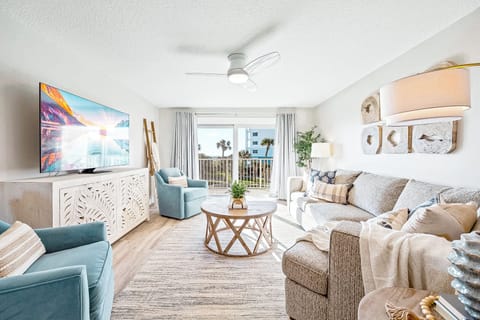 Cozy and coastal living room with soft textures and a stunning ocean view