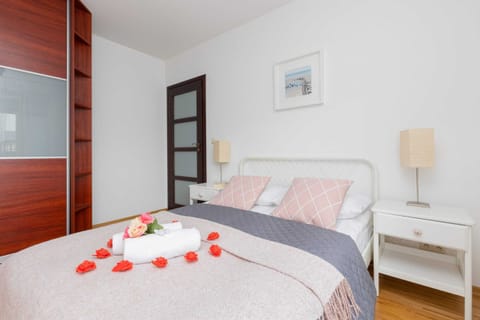 A cozy bedroom with a soft double bed, bedside lamps, and a relaxing ambiance.
