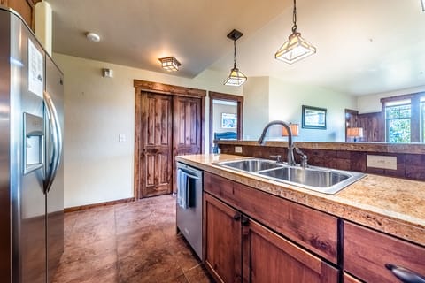 Kitchen - Double sink, ample counter space, and a variety of cooking utensils for creating the perfect vacation meal.