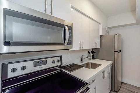 Featuring large kitchen sink and flat cook top