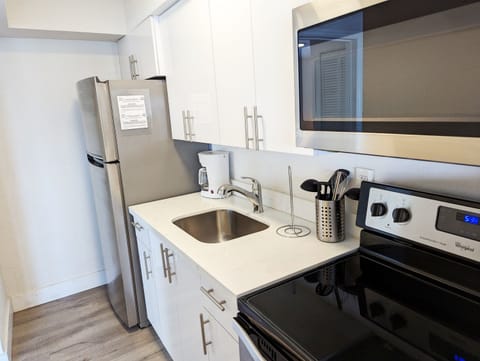 Quartz countertop, deep sink and stainless steel. 2m video tour link sent after booking includes open cabinets showing supplies.