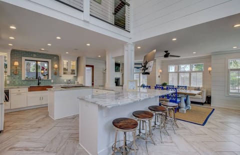 A chef's kitchen with an island for seating and food preparation.