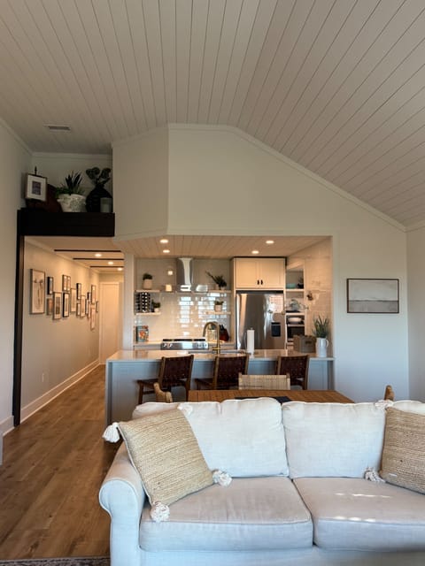 Beautiful all white gourmet kitchen has counter seating for three.
