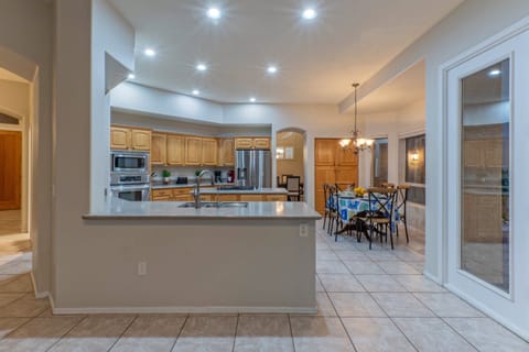 The modern and open kitchen has doors that access the backyard oasis.