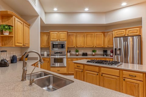 Contemporary kitchen includes expansive counter space for prepping and serving home cooked feasts.