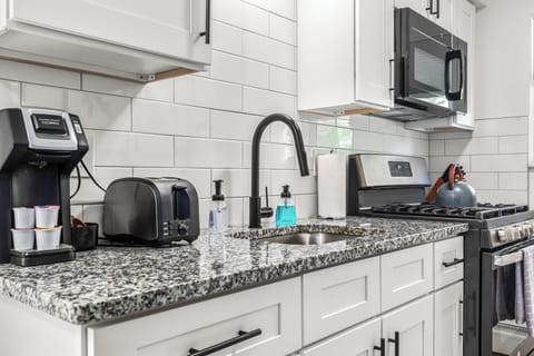 Start your day off right with a delicious breakfast made in this cozy kitchen.