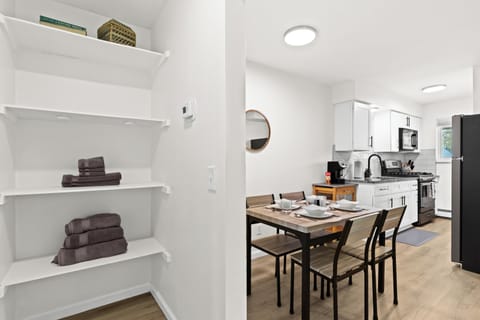 Convenient Linen Closet Equipped with Extra Towels, Cleaning Supplies, and Laundry Basket