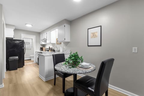 Gather with friends and family for a delicious meal in this cozy dining room.