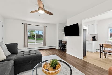 Comfy living space with work desk and mounted Smart TV