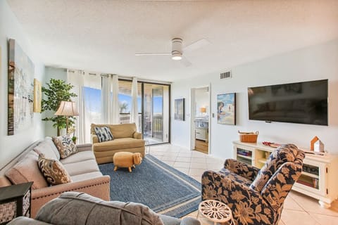 - Relax in a bright, beachy living room with comfy sofas, a smart TV, and plenty of seating
- Sliding glass doors let in sunshine and lead to a private balcony with views
- Thoughtful decor and plush rugs create a homey coastal feel