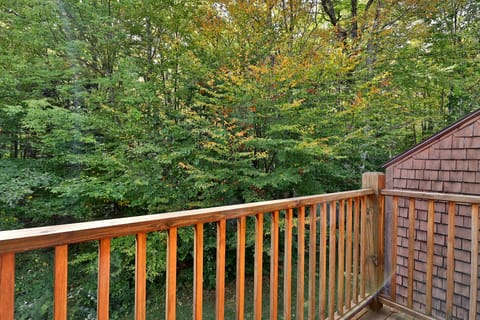 Balcony with view of surrounding woods