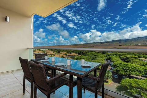 Your private lanai beckons with panoramic mountain and coastal vistas stretching to the horizon.