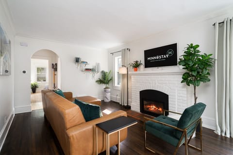 Sink into plush leather seating by your crackling fireplace, where warm light and lush greenery create the perfect retreat after your adventures.