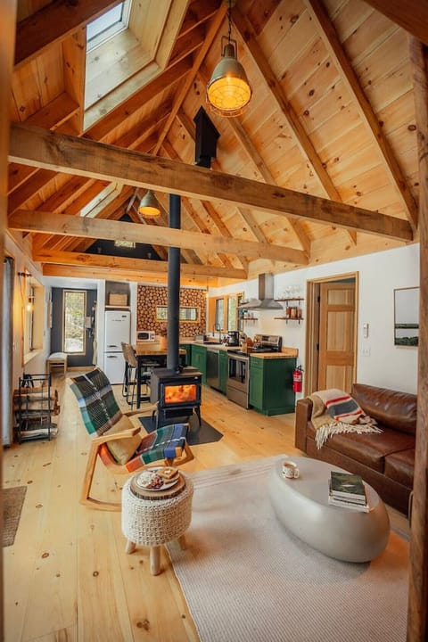 The main living space has a unique cabin feel, centered by the wood stove.