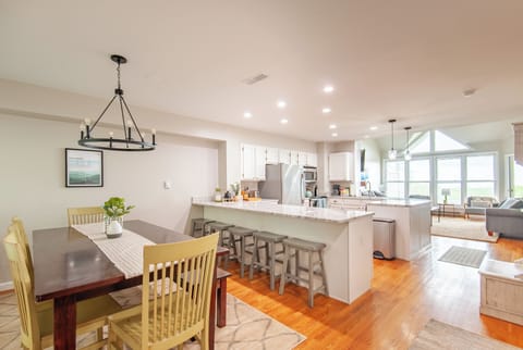 Main living floor contains dining, kitchen, living room, and half bath.