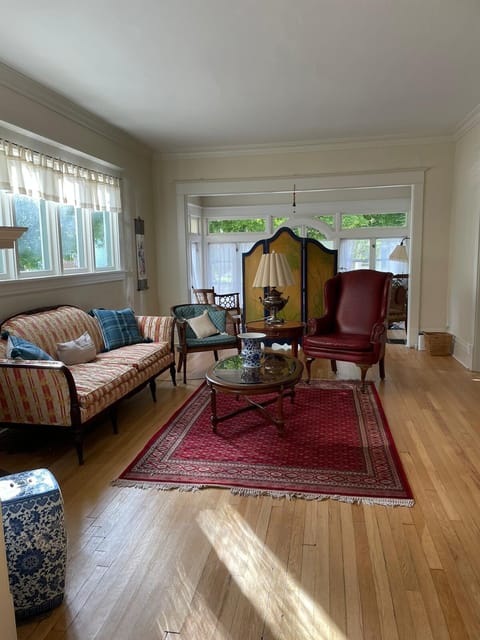 Living area with comfortable seating for five. Sunroom and dining room attached.