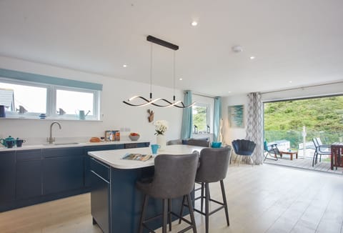 Anneth Lowen, Polzeath. Well equipped kitchen area with contemporary units, American Fridge/freezer, electric oven and ceramic hob, microwave and dishwasher