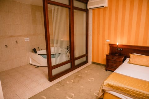 Luxury Suite, 1 King Bed | Bathroom | Shower, hair dryer, bathrobes, slippers