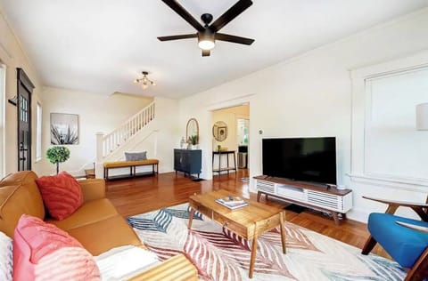 Open, bright living room with large TV and includes streaming services