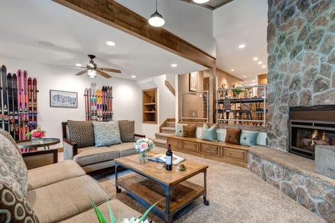 Living Room with cozy gas fireplace, Smart TV, plush furnishings, vaulted ceiling, and patio access.