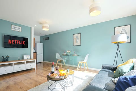 Sit back and relax in the living room equipped with a large 50'' Smart TV and a comfortable 3 seater sofa