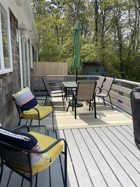 Deck with grill and outdoor seating. 