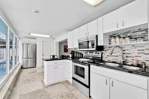Cook in style! This bright kitchen features granite counters, stainless appliances, and plenty of natural light — perfect for home-cooked meals during your stay.
