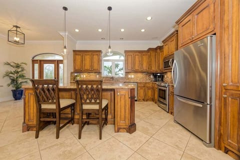 Cook and entertain effortlessly in this open kitchen with modern appliances, drip coffee maker, and easy access to indoor and outdoor living areas.