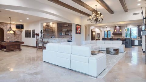 Luxury couches near the bar & pool table w/ TV for entertainment for everyone