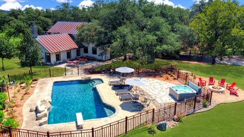 Aerial view of the rear of the main house with pool and hot tub.