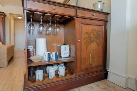 Keurig coffee maker, glasses, plates, and cutlery.