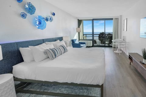 Wake up to endless ocean views in this spacious, sun-filled retreat. With a plush king bed, cozy lounge area, and private balcony, it's the perfect blend of comfort and coastal charm for a relaxing beach getaway.