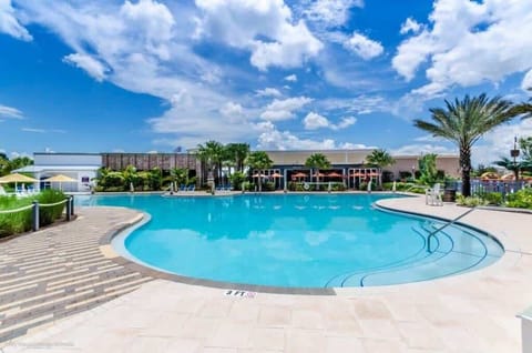 - Resort style pool with wide deck, palm views, and clear blue water for sunny days  
- Spacious community pool area with loungers, umbrellas, and open sky scenery  
- Ideal vacation setting near clubhouse amenities, walk paths, and green lawns  
