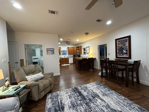 Open den with windows overlooking the back porch. 