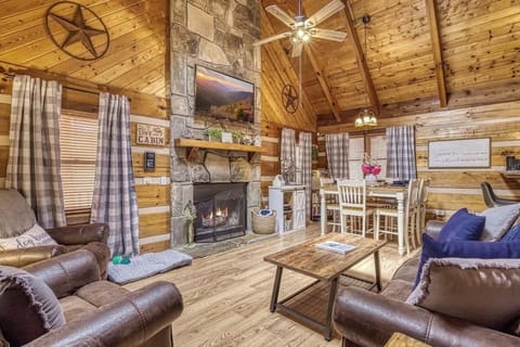 Rustic charm awaits with a stone fireplace, soaring ceilings, and inviting seating!