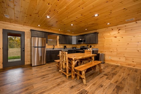 Kitchen area with dining table door to rear patio