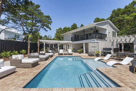 Sun-splashed pool w/ comfy loungers, perfect for cooling off & soaking up the Florida vibes.
