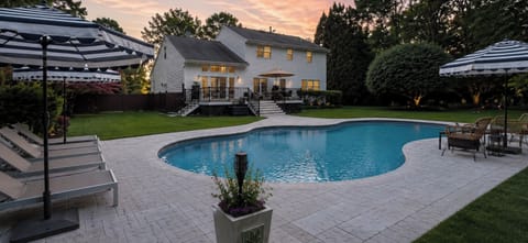 Resort inspired backyard with heated pool, outdoor seating, and complete privacy