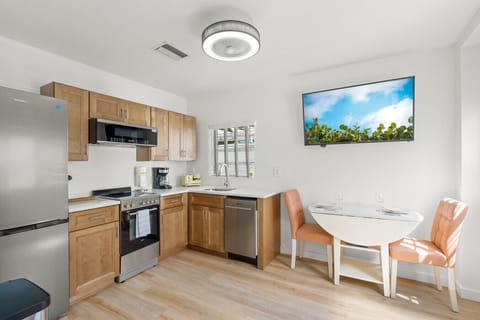 Siesta Key Beach Retreat features a modern kitchen with a cozy dining nook, stainless-steel appliances, and a streamlined design for effortless island living.