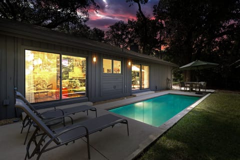 Side yard of home featuring heatable pool (additional charge applies- electric heater)