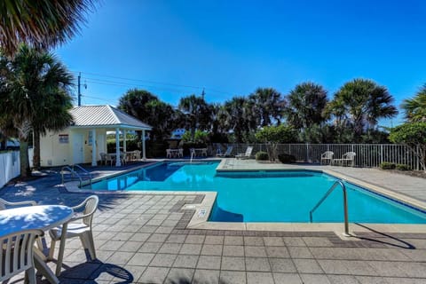Pool area with seating and lounge chairs, and public bathrooms