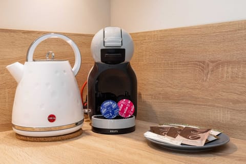 A countertop setup including a kettle and coffee machine, offering a welcoming touch.