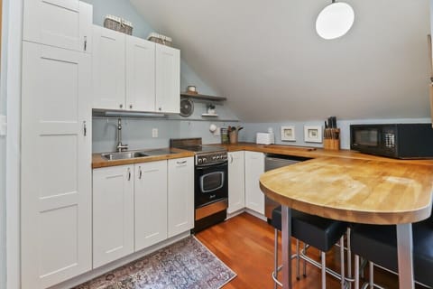 Small but mighty! Microwave, toaster, small fridge, oven and cook top. Coffee maker also available. Portable dishwasher available. Full size fridge in the garage.