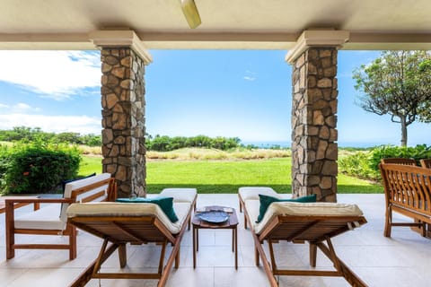 Spacious covered patio with plush seating and ocean views