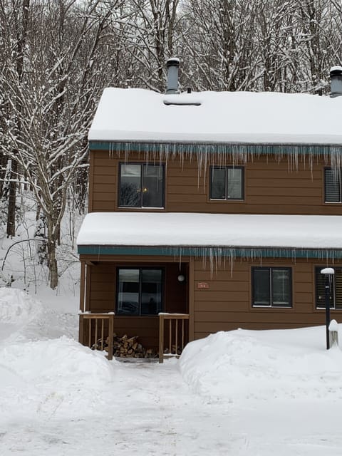 Exterior view of condo amidst backdrop of the mountain.