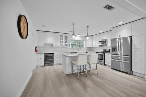 Modern kitchen with new appliances and breakfast bar that seats 2