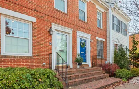 A classic and welcoming exterior with beautiful landscaping, perfect for a cozy and inviting stay.