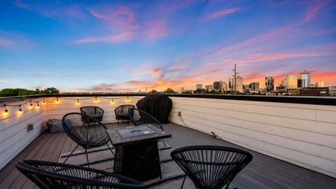 Gather around the rooftop fire pit with drinks and skyline views.